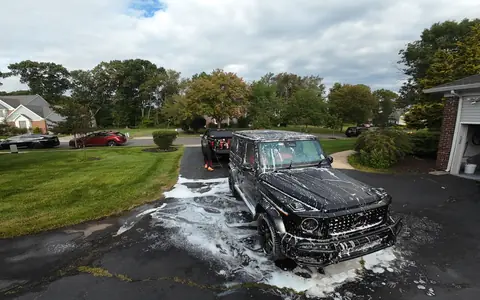 A G63 under a full coat of snow foam in a Bucks County driveway